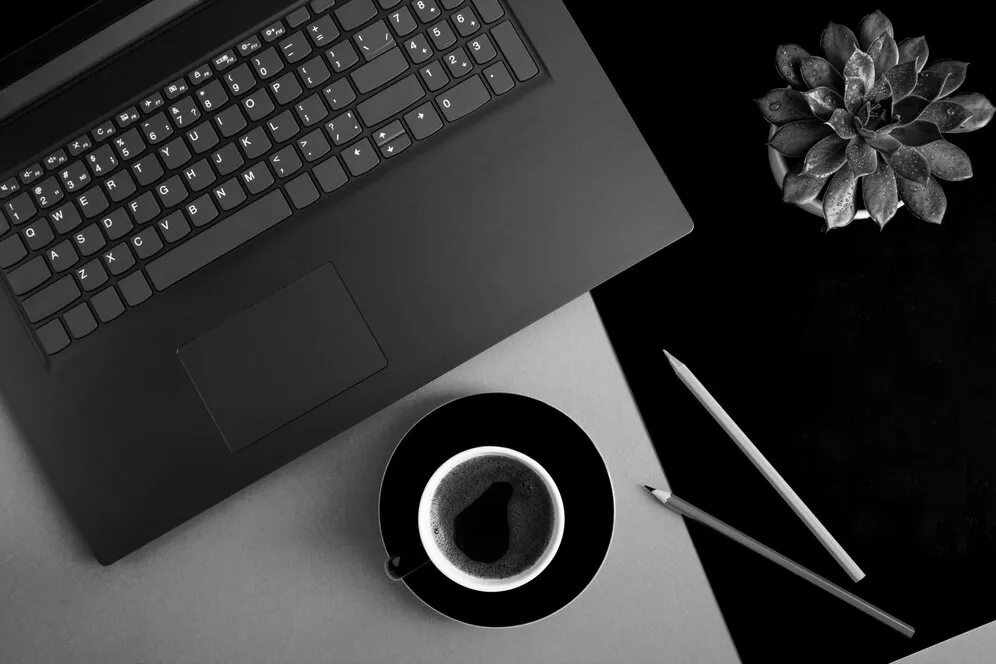 Top view office desk with laptop coffee cup cactus pencils black gray background flat lay 271740 6106